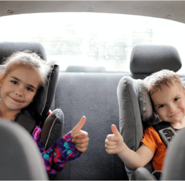 Happy children being entertained in the car